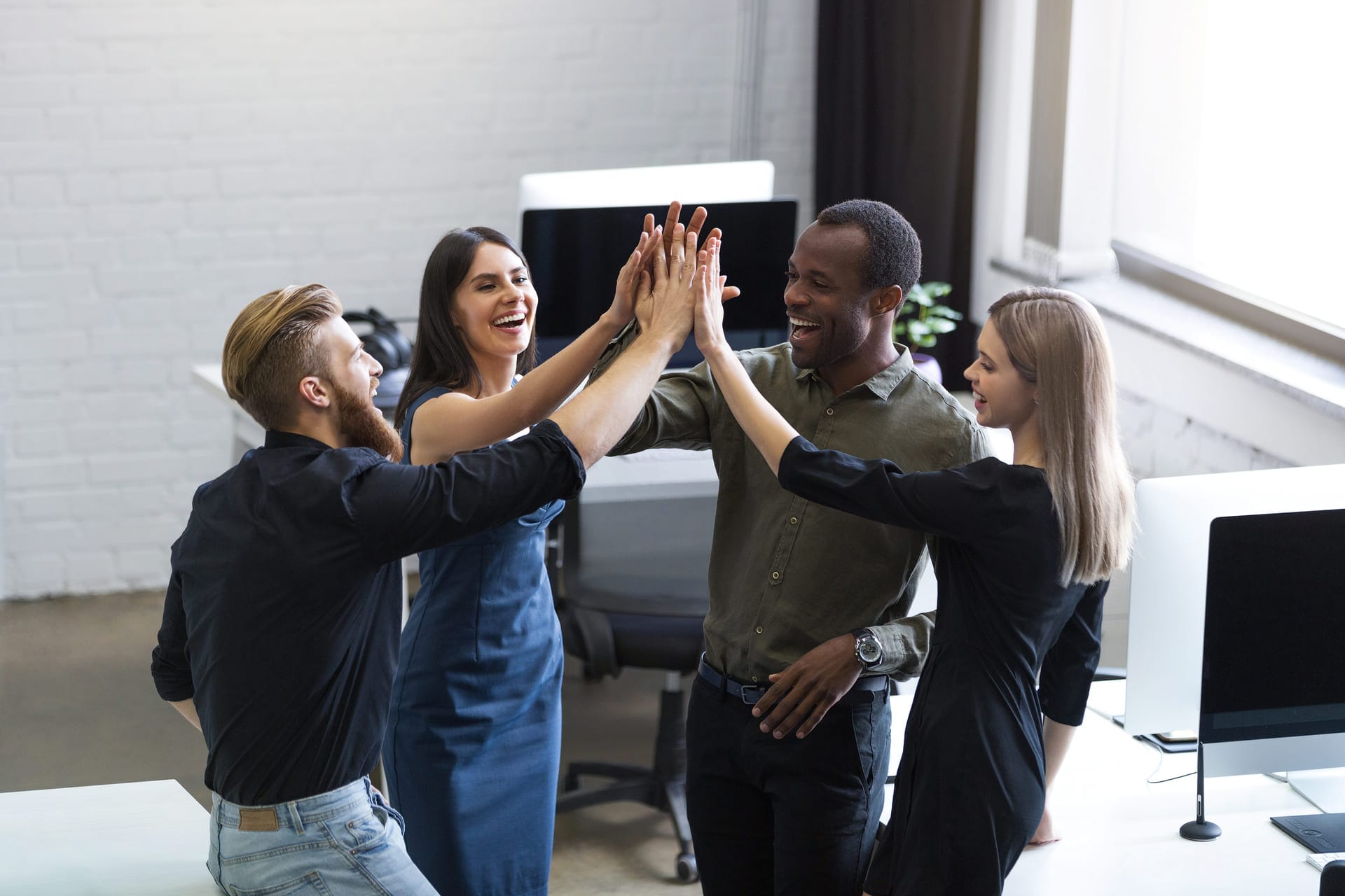 group-young-colleagues-giving-each-other-high-five (1)