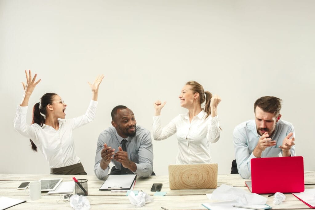 young-men-women-sitting-office-working-laptops-emotions-concept (1)
