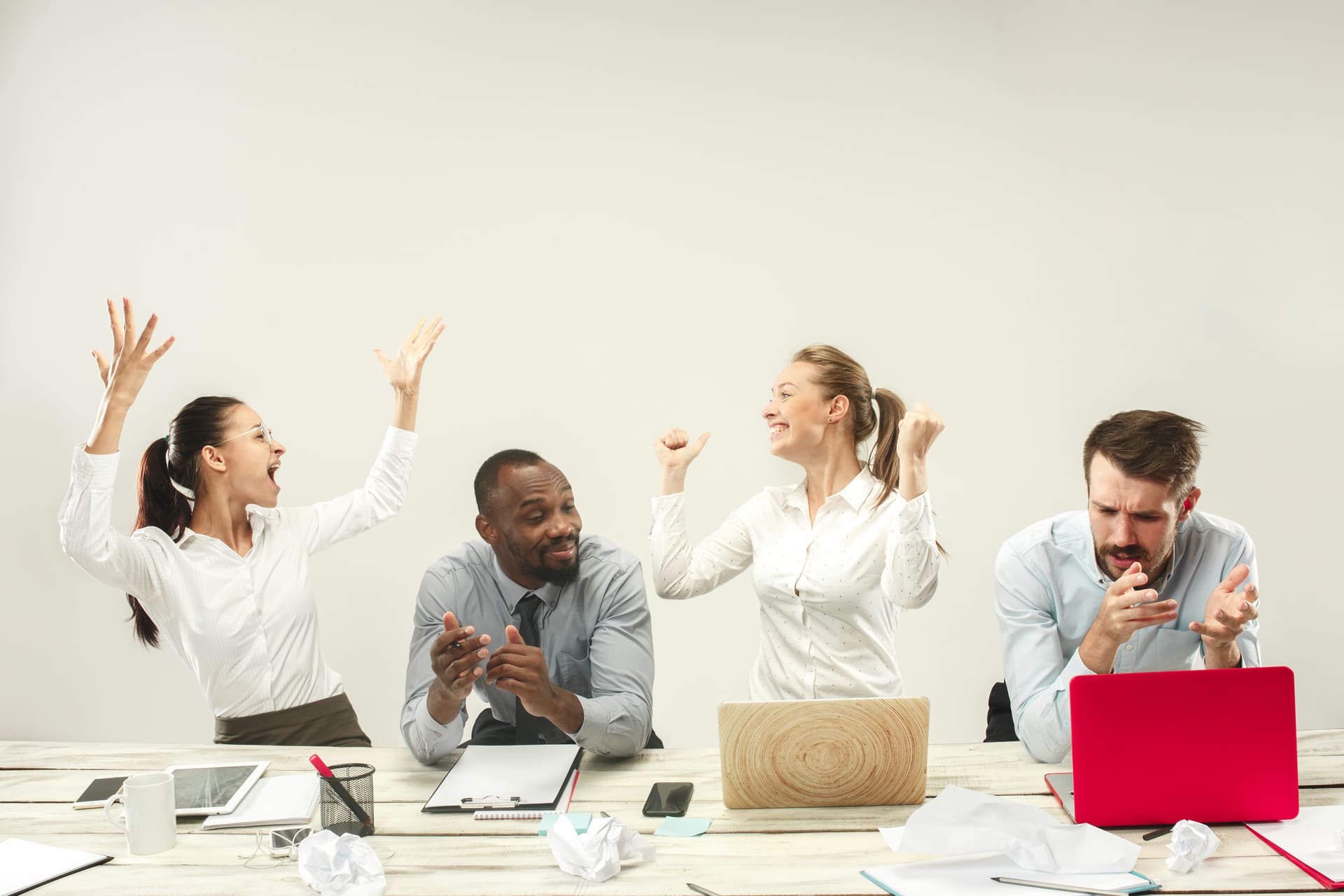 young-men-women-sitting-office-working-laptops-emotions-concept (1)